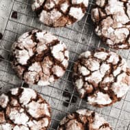 The best Chocolate Crinkle Cookies recipe freshly baked and cooling on a wire rack.