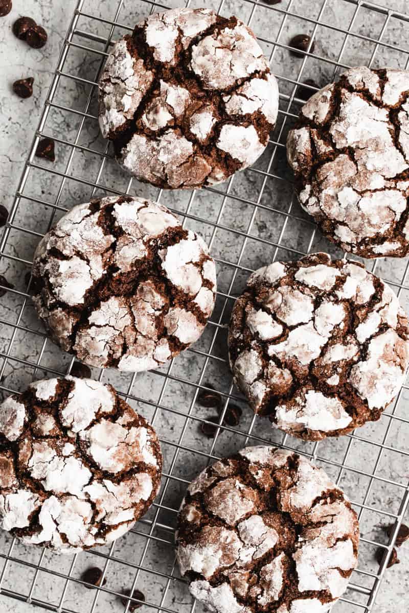 The best Chocolate Crinkle Cookies recipe freshly baked and cooling on a wire rack. 