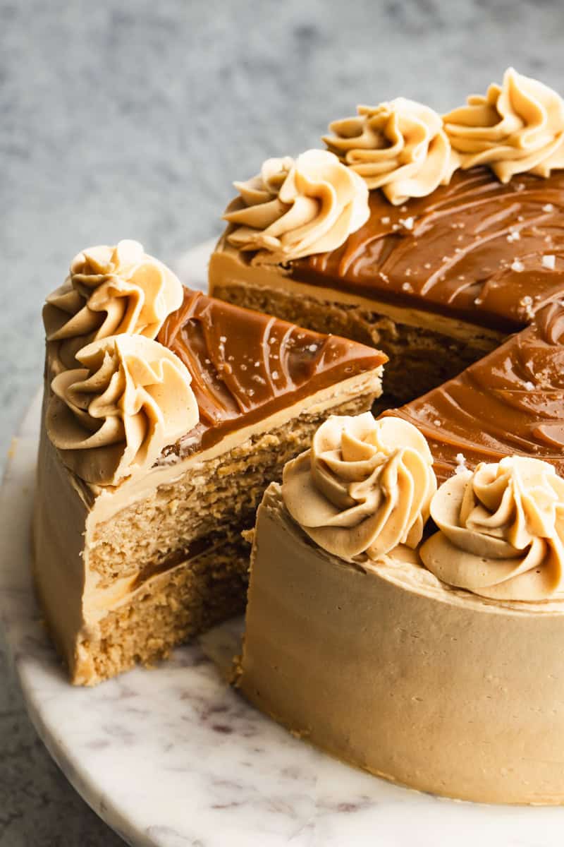 An easy Dulce de Leche Cake recipe with one slice being separated to serve.