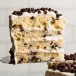 An easy Cannoli Cake recipe with a slice lifted up to show the layers.