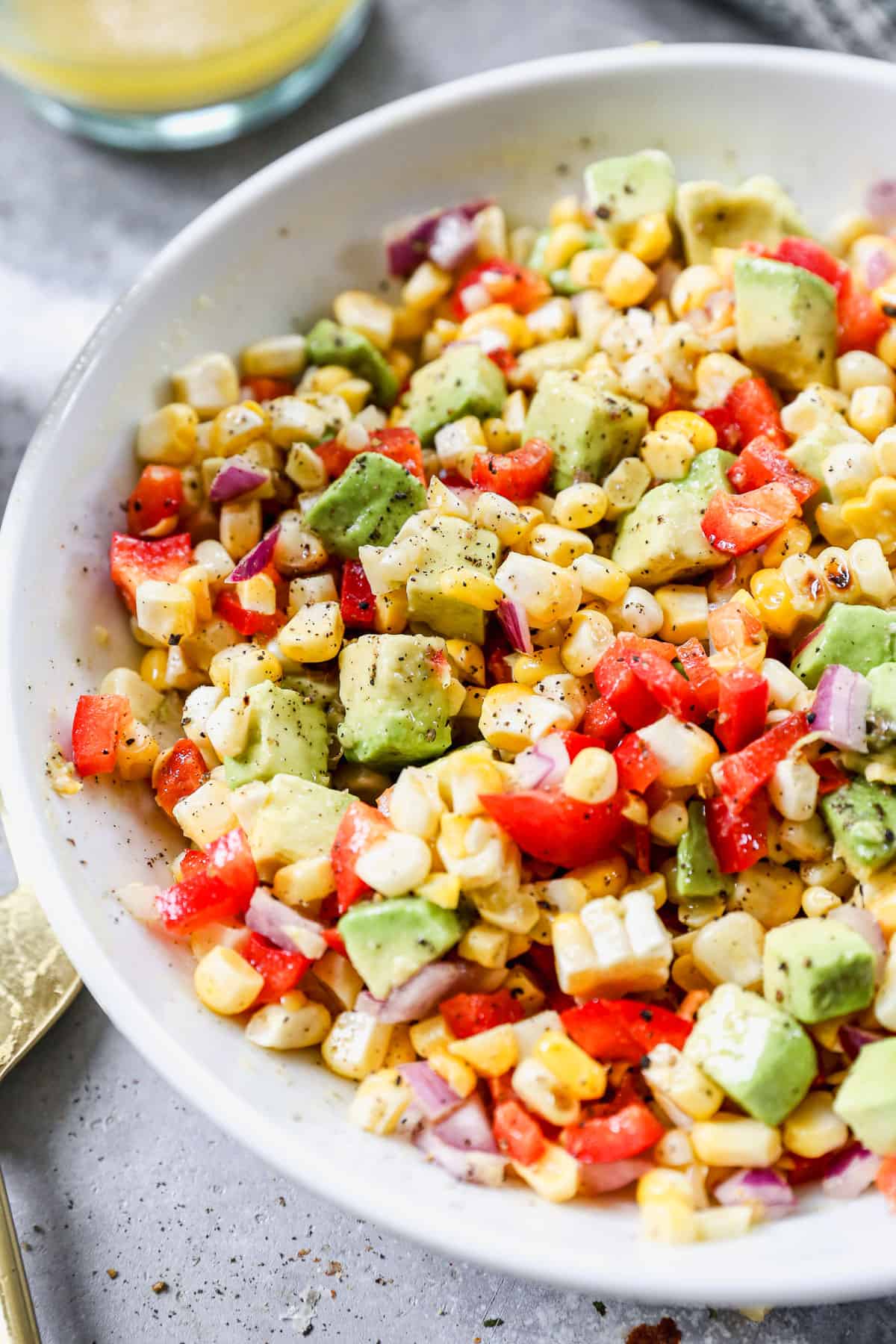 A bright and colorful Grilled Corn Salad with corn, avocado, bell pepper, onion, and a simple dressing. 