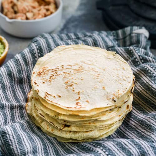 A stack of homemade Corn Tortillas, ready to use in tacos or enchiladas.