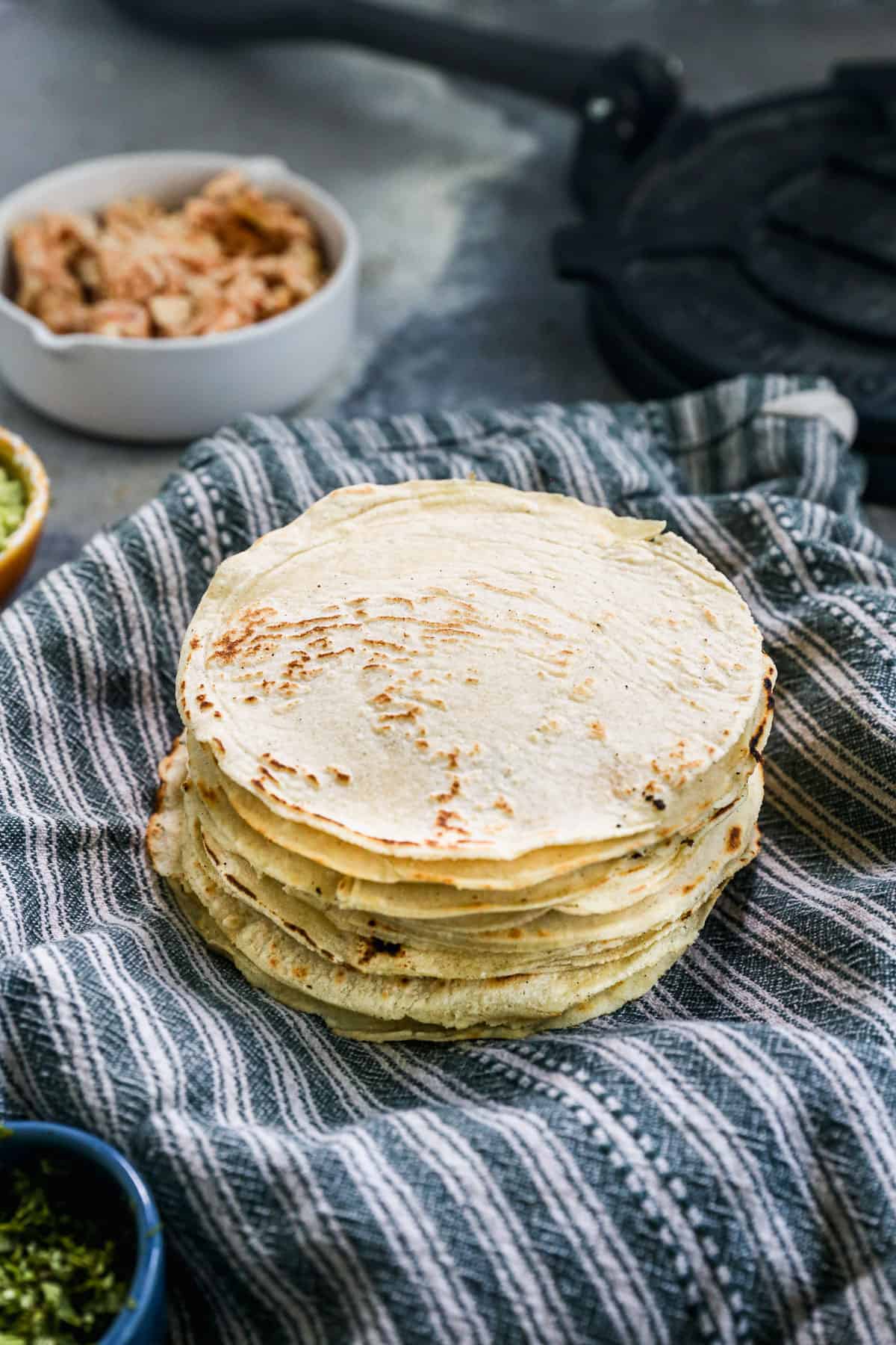 A stack of homemade Corn Tortillas, ready to use in tacos or enchiladas.