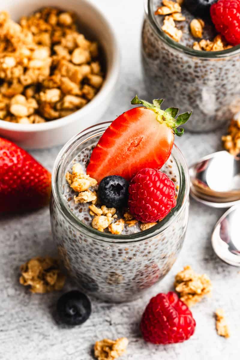 Overnight Chia Pudding recipe in a jar topped with granola and berries, ready to enjoy.