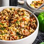 An easy Breakfast Fried Rice recipe in a bowl, with scrambled eggs, Canadian bacon, sausage, and veggies.