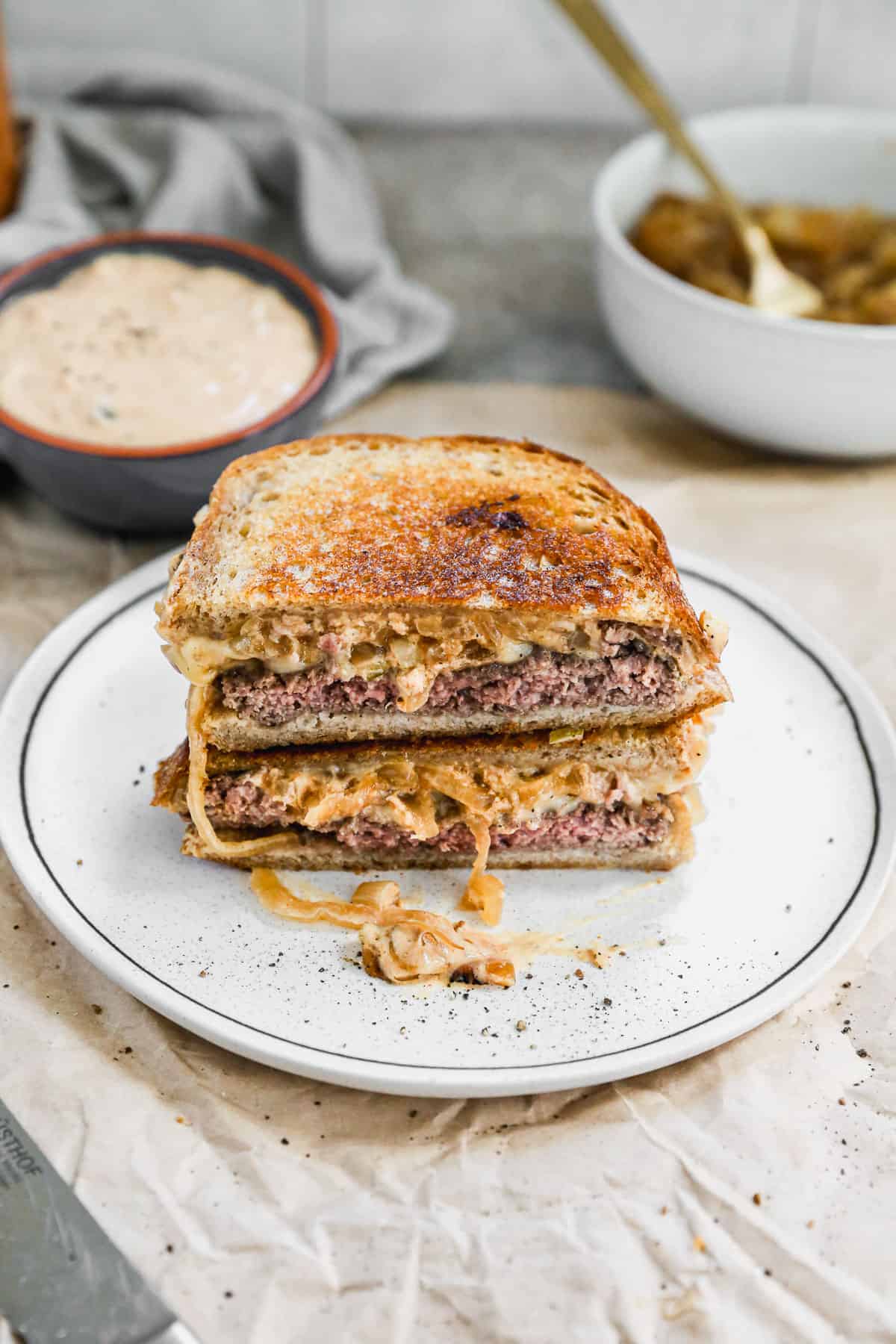 The best Patty Melt on sourdough bread, cut in half and stacked on top, ready to eat.