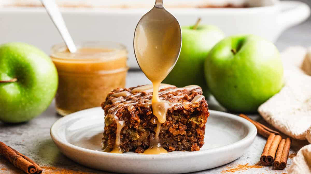 This Fresh Apple Cake is a homemade spice cake loaded with grated apples and topped with a delicious caramel sauce.