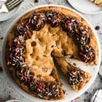 This Chocolate Chip Cookie Cake recipe is quick and easy to make at home and has that irresistible soft and chewy center! More affordable and tastes better than store-bought!