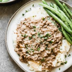 This simple Hamburger Gravy recipe is affordable, easy, and on the table in 20 minutes. Best part, my kids devour it every single time!
