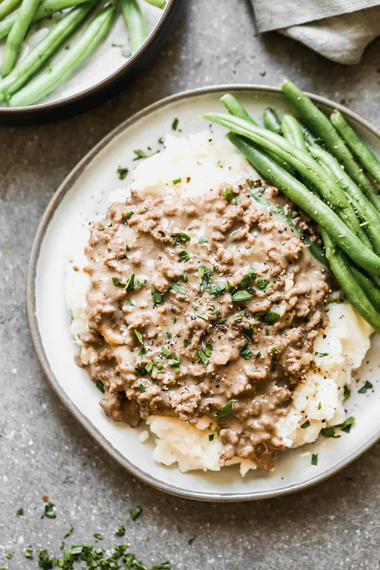This simple Hamburger Gravy recipe is affordable, easy, and on the table in 20 minutes. Best part, my kids devour it every single time!