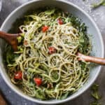 A creamy Pesto Pasta recipe with spaghetti tossed in a homemade pesto sauce then mixed with fresh tomatoes, arugula, and parmesan cheese.