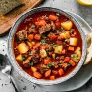 A traditional Hungarian Goulash recipe served in a bowl with a side of crusty bread.