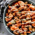 An easy Patatas Bravas recipe with crispy potatoes, bravas sauce, and a garlic aioli served in a bowl.