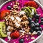 Easy Pitaya Bowls are made in the blender in just 5 minutes and is flavorful and refreshing and topped with granola, coconut, and fresh fruit. It's any picky eaters favorite!