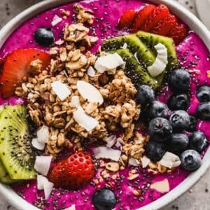 Easy Pitaya Bowls are made in the blender in just 5 minutes and is flavorful and refreshing and topped with granola, coconut, and fresh fruit. It's any picky eaters favorite!