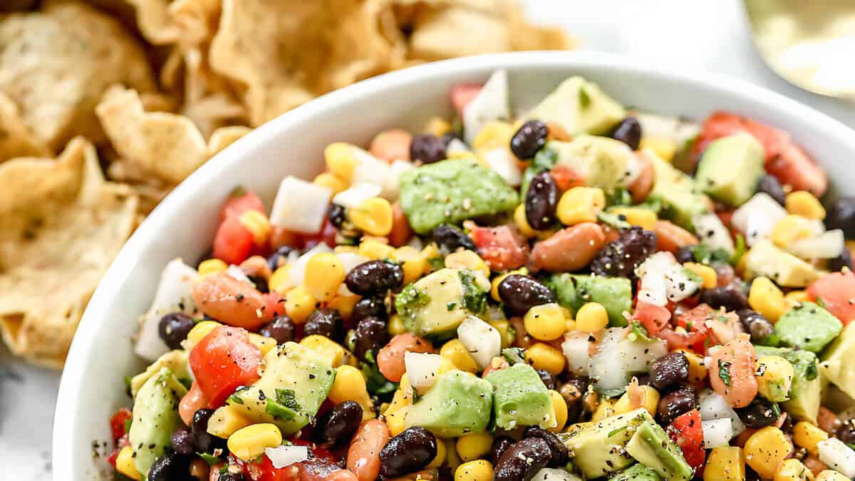 Colorful cowboy caviar loaded with black beans, corn, bell peppers, and a zesty homemade dressing- great as a dip or side.