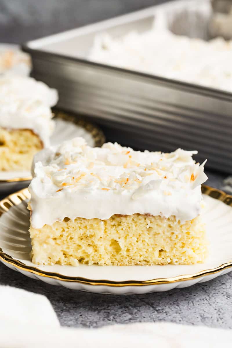 The best Coconut Tres Leches Cake has a fluffy sponge cake with a coconut milk twist and topped with whipped cream and coconut flakes. It's the perfect light dessert!
