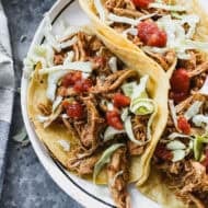 A plate of Slow Cooker Chicken Tacos ready to enjoy with the most delicious meat that can be meal prepped and used in a variety of dishes all week!