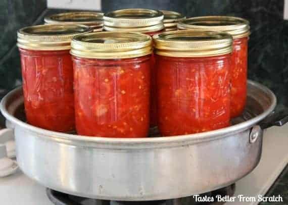 Homemade Canned Tomatoes in mason jars and gold lids. Such a great way to savor garden-fresh tomatoes and enjoy them in pasta dishes, salsa, or more all year round.