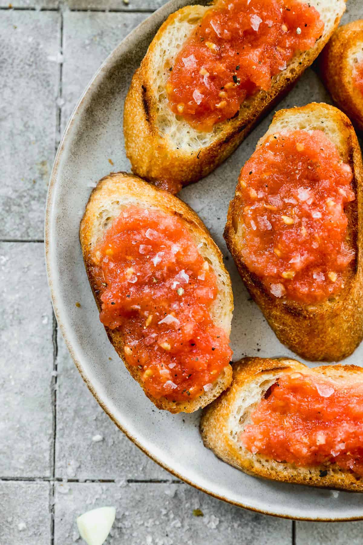 Rustic toast meets fresh tomato and garlic for a 5-minute snack that is bursting with simple, but bold flavor.