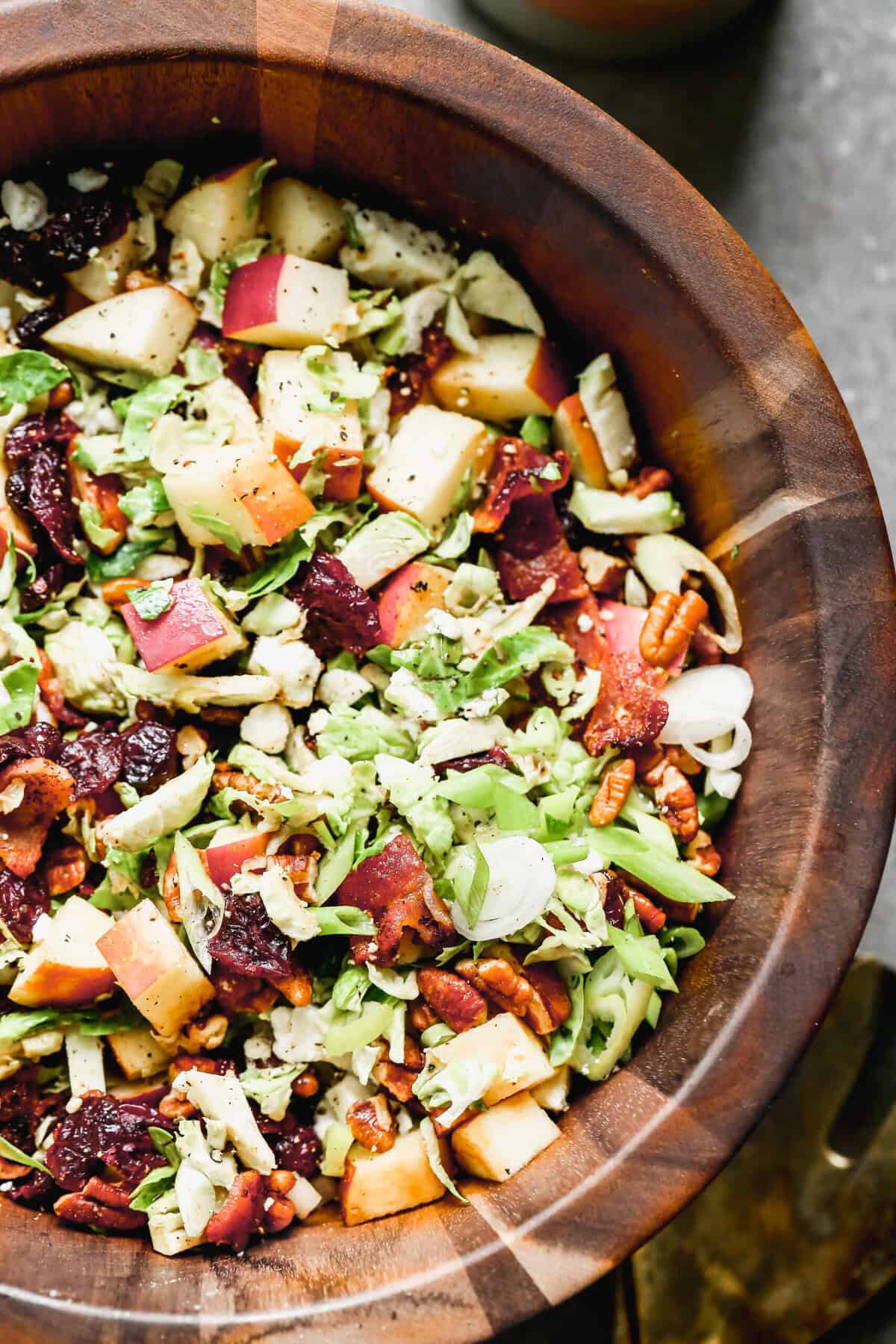 A light and satisfying side of shaved Brussels sprouts tossed with dried cranberries and toasted pecans, dressed in a simple vinaigrette.