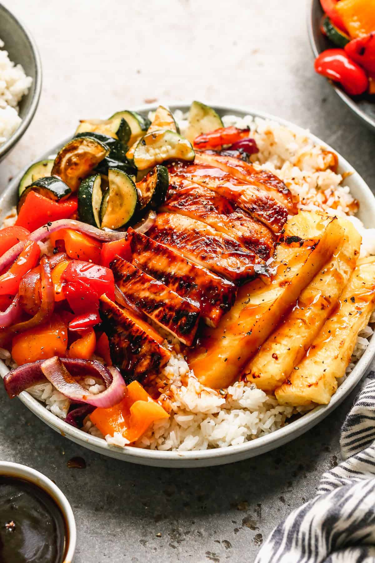 Grilled teriyaki chicken, pineapple, and veggies over coconut rice bring sunny island flavor to your dinner table in a bowl thatโs as fun as it is filling.
