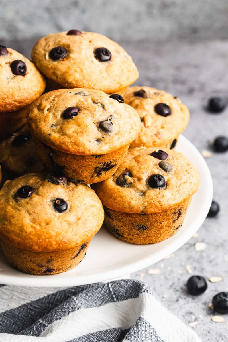 A plate stacked with Healthy Muffins with oats, blueberries, honey, and wholesome ingredients ready to enjoy.