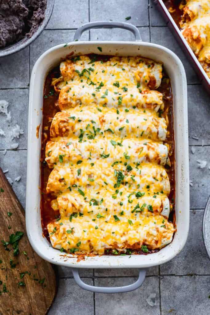 Homemade Chicken and Rice Enchiladas are packed full of flavor and are easy to double and make two pans, one to enjoy now and one to freeze for later.