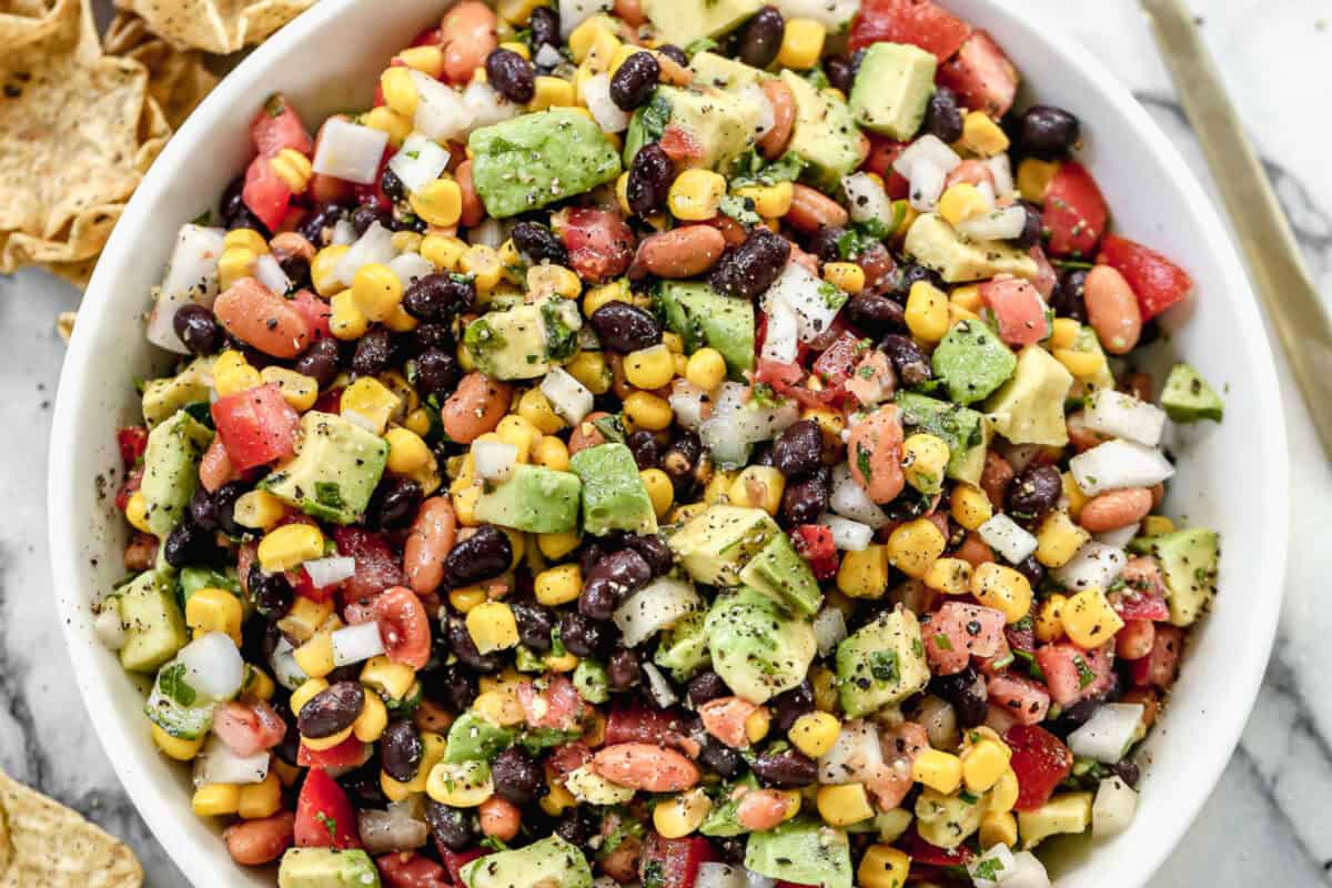 This zesty cowboy caviar bean and veggie mix is perfect for scooping or spooning over tacos.