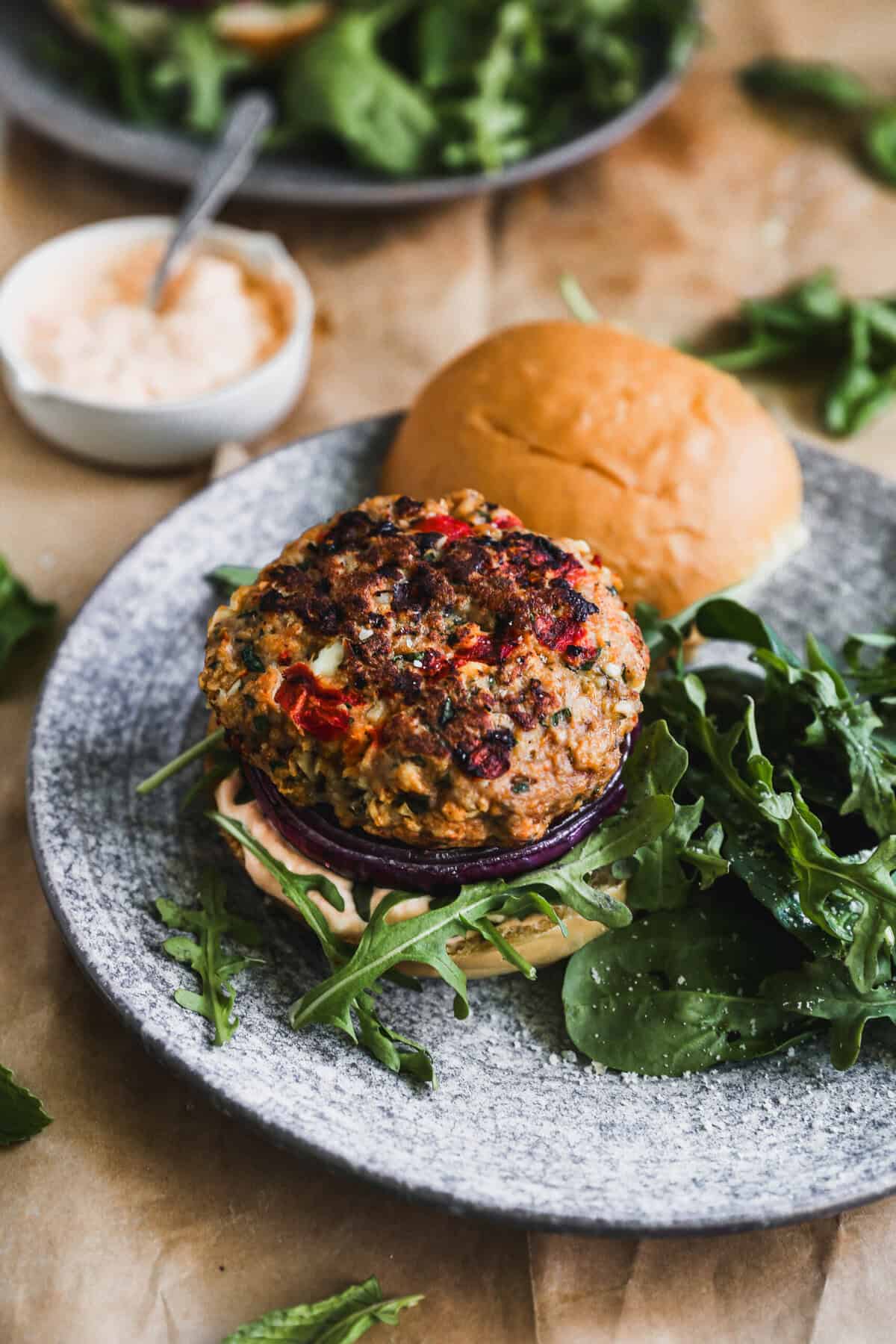 A Greek burger with feta aioli and arugula that adds bright Mediterranean flavor to a cozy date-night meal.