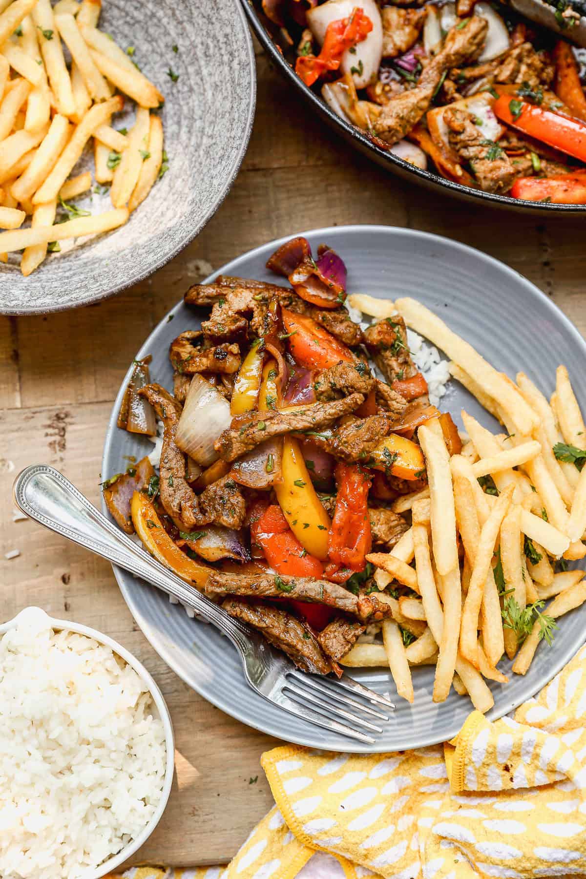 This flavorful Peruvian lomo saltado recipe turns leftover rice into a complete meal with steak, veggies, and fries.