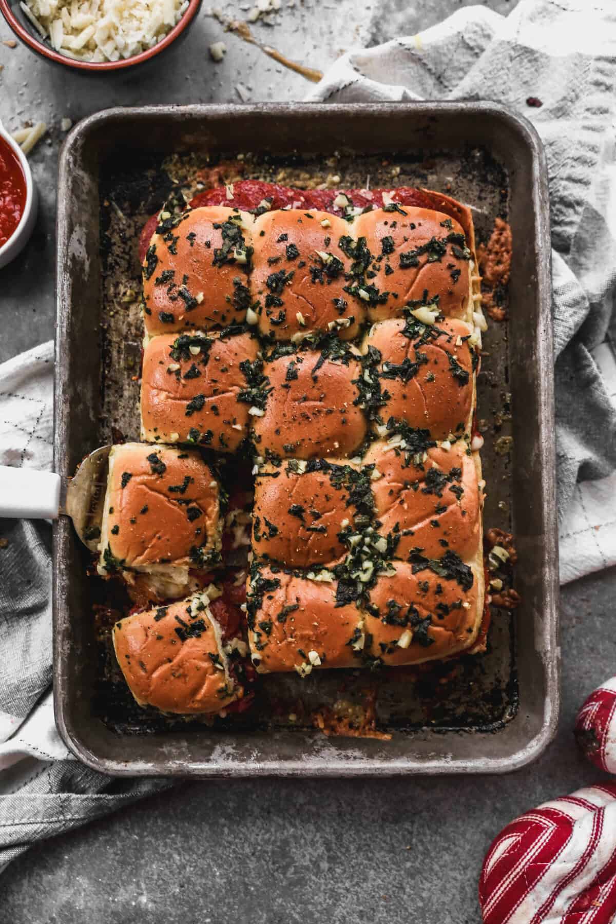 These pizza sliders are a fast and fun way to serve pizza flavors for parties, lunchboxes, or weeknight meals.