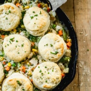 The best Biscuit Chicken Pot Pie recipe has a flavorful and creamy chicken and veggie filling and topped with homemade buttery, flaky biscuits. It's a comforting family favorite!