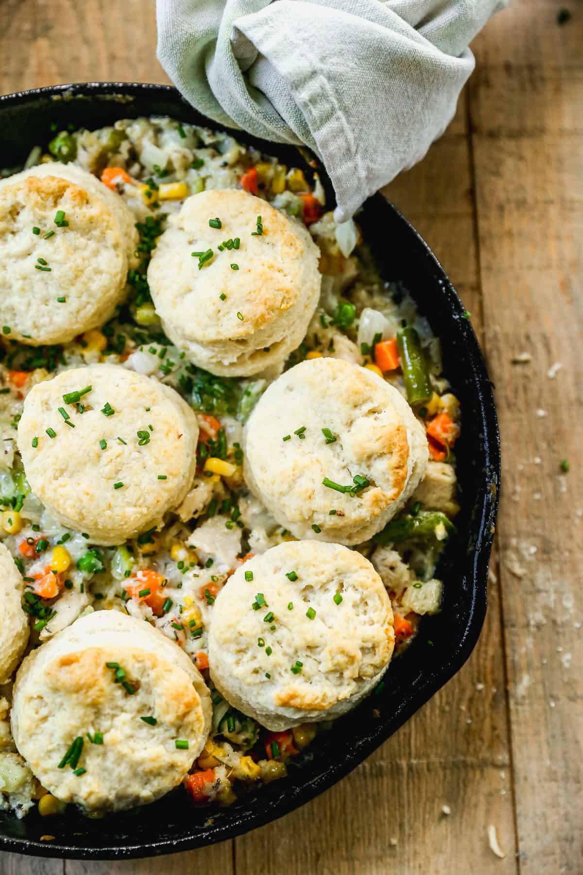 The best Biscuit Chicken Pot Pie recipe has a flavorful and creamy chicken and veggie filling and topped with homemade buttery, flaky biscuits. It's a comforting family favorite!