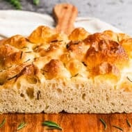 This homemade focaccia recipe is fluffy inside with crisp edges and can be topped with herbs, olives, or tomatoes for endless variations.