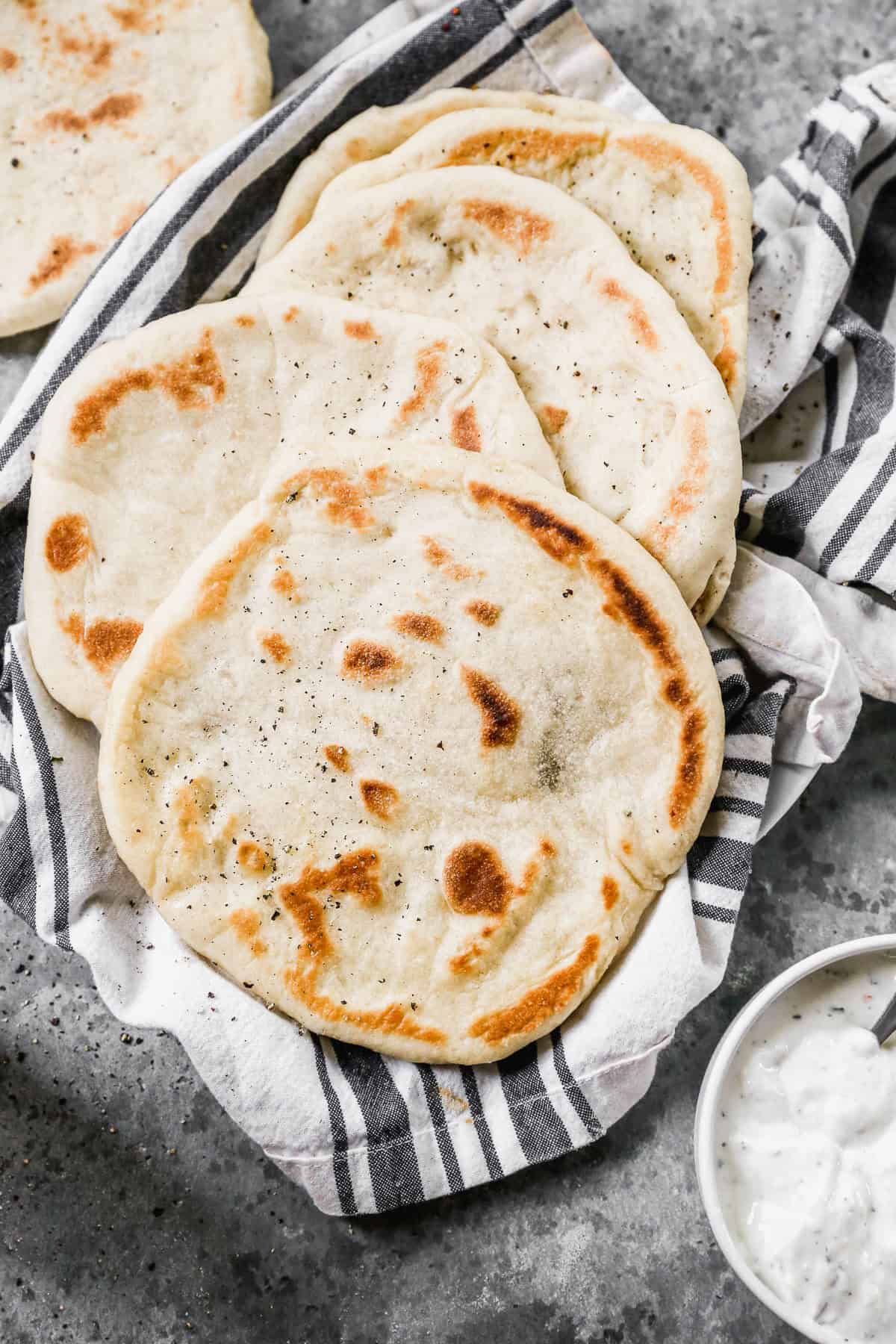 Homemade pita bread is perfect for wraps, sandwiches, and dipping, plus it's fun to make at home.