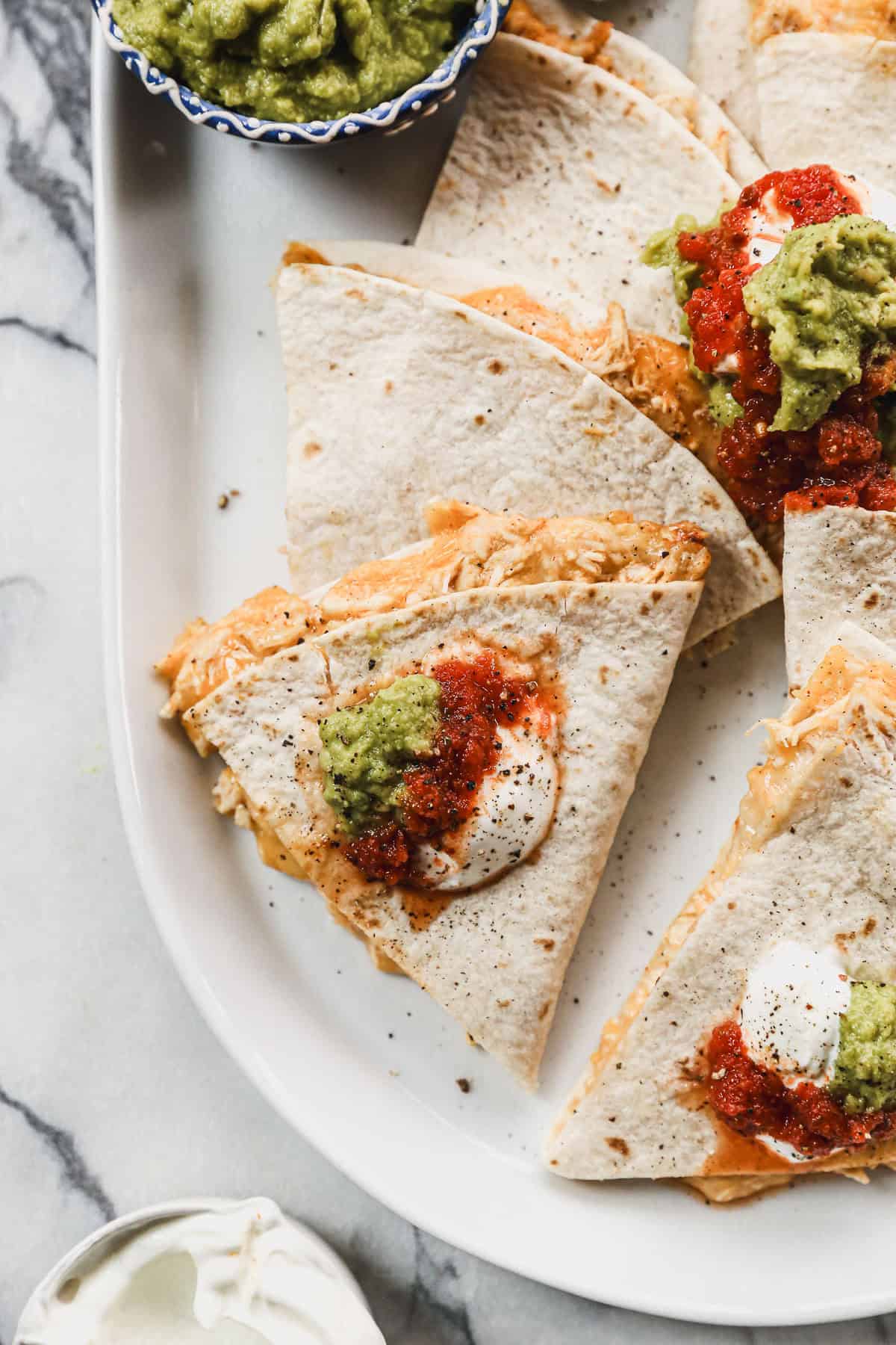 These chicken quesadillas are a fast and family-friendly meal that comes together with pantry staples and tons of melty goodness.