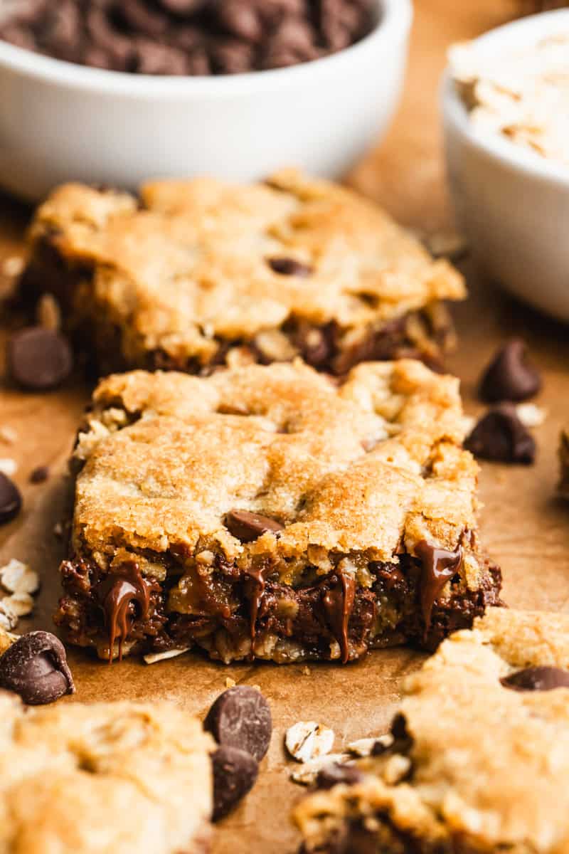 Homemade Oatmeal Chocolate Chip Bars cut into squares on parchment paper, ready to enjoy.