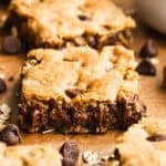 Homemade Oatmeal Chocolate Chip Bars cut into squares on parchment paper, ready to enjoy.