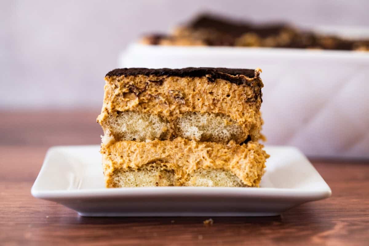 This easy Pumpkin Tiramisu recipe has a perfectly spiced pumpkin mascarpone layered with espresso dipped ladyfingers and dusted with cocoa powder. It's the perfect seasonal twist on the tiramisu we love!