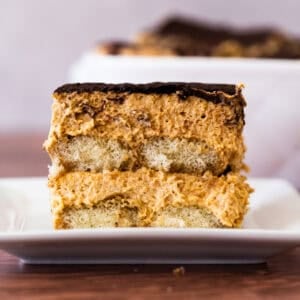 This easy Pumpkin Tiramisu recipe has a perfectly spiced pumpkin mascarpone layered with espresso dipped ladyfingers and dusted with cocoa powder. It's the perfect seasonal twist on the tiramisu we love!
