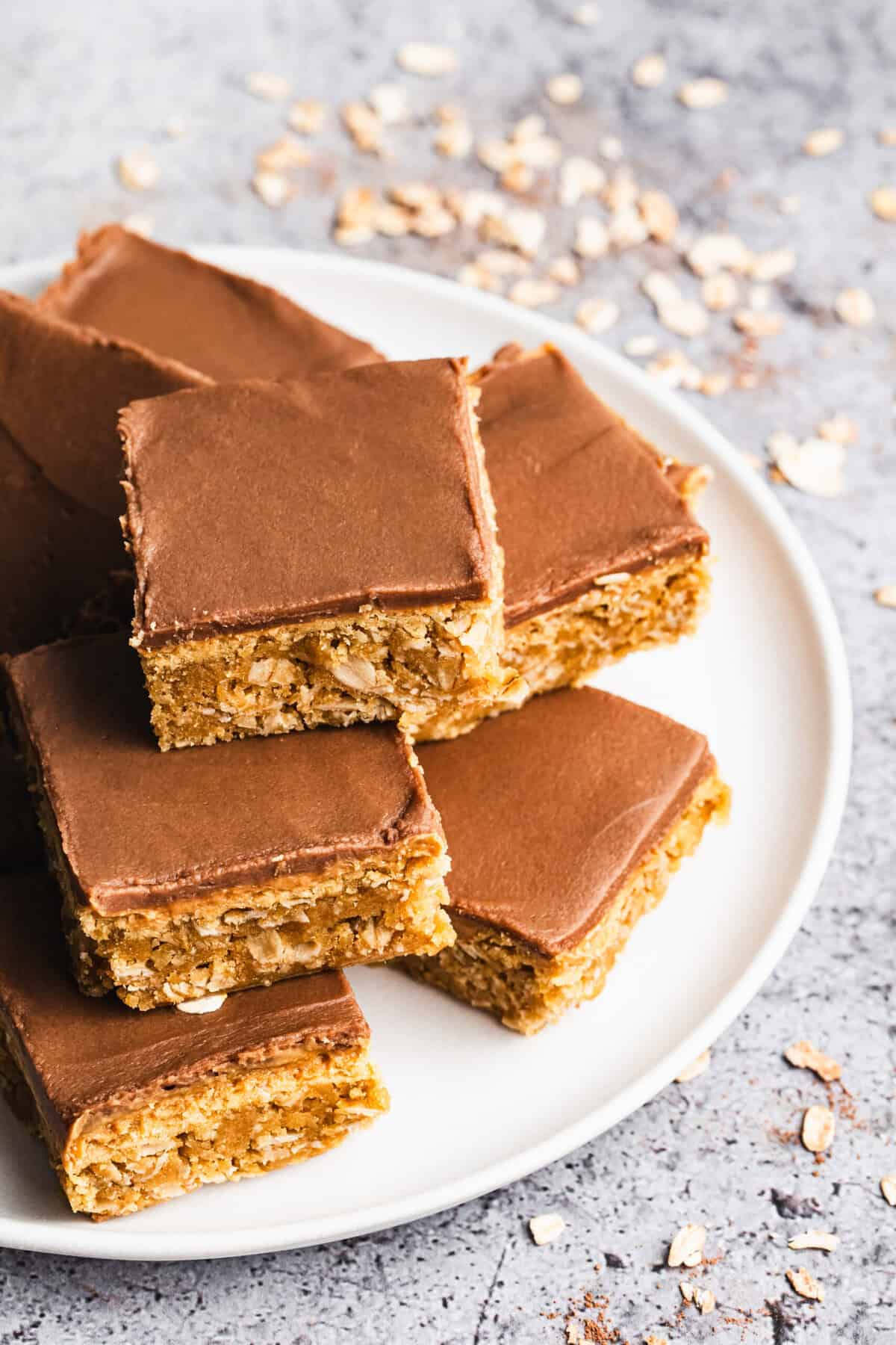 Peanut Butter Bars have a chewy oat base, a creamy peanut butter layer, and a smooth chocolate glaze. Perfect for making ahead and sharing.