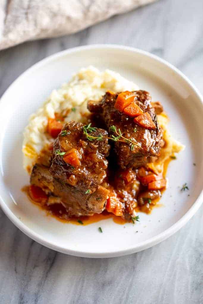 This braised short ribs recipe offers deep, comforting flavor in tender meat cooked with veggies and herbs.
