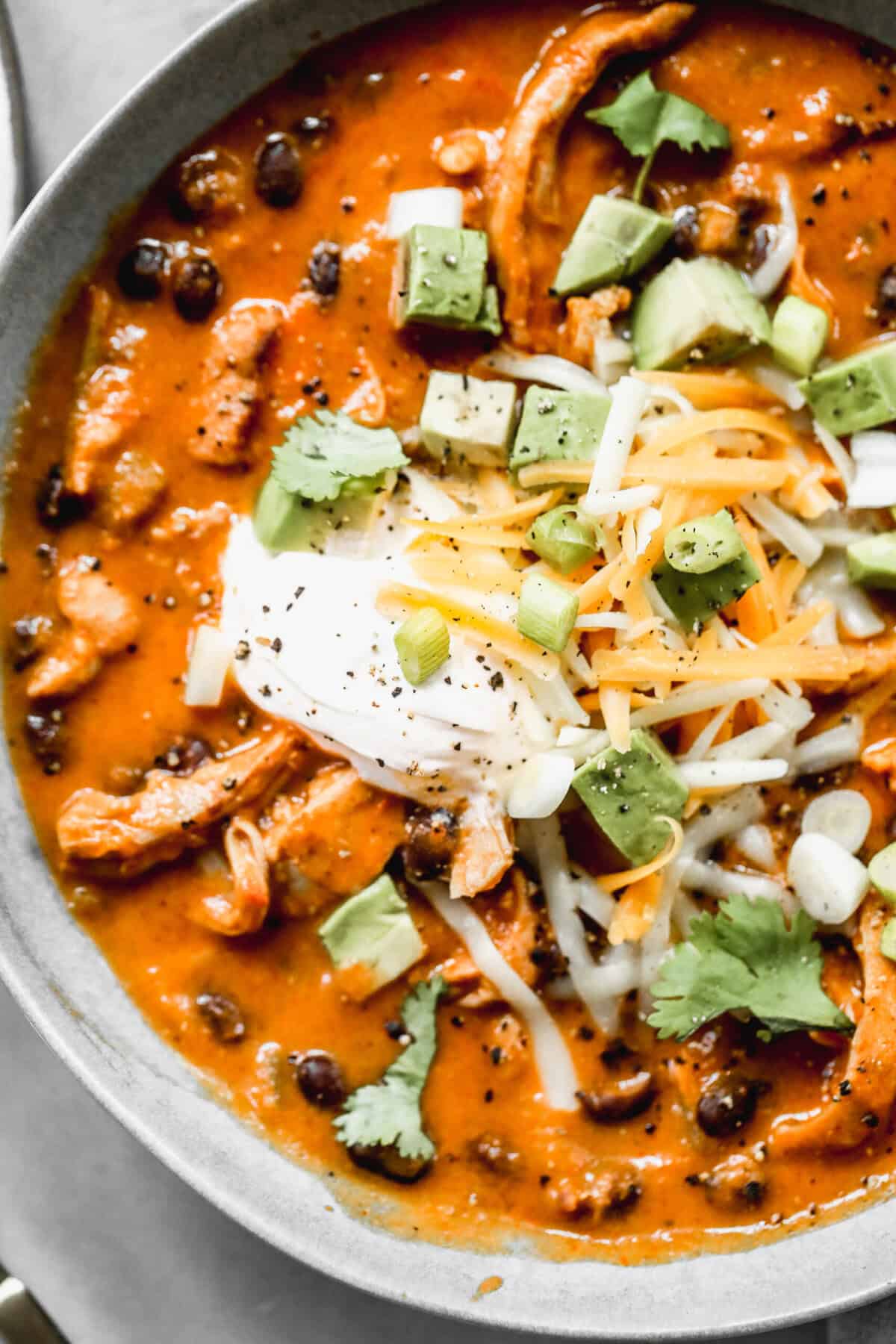 Chicken Enchilada Soup is a fast, flavorful one pot meal loaded with toppings and perfect for cozy dinners or next-day leftovers.