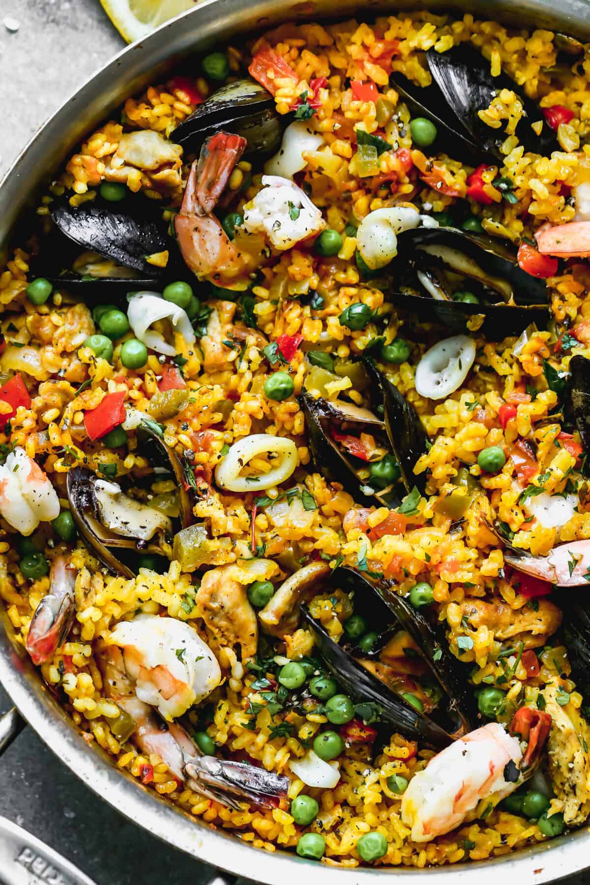 Paella brings Spanish flair to Thanksgiving with its colorful presentation and layers of flavor in one impressive pan.