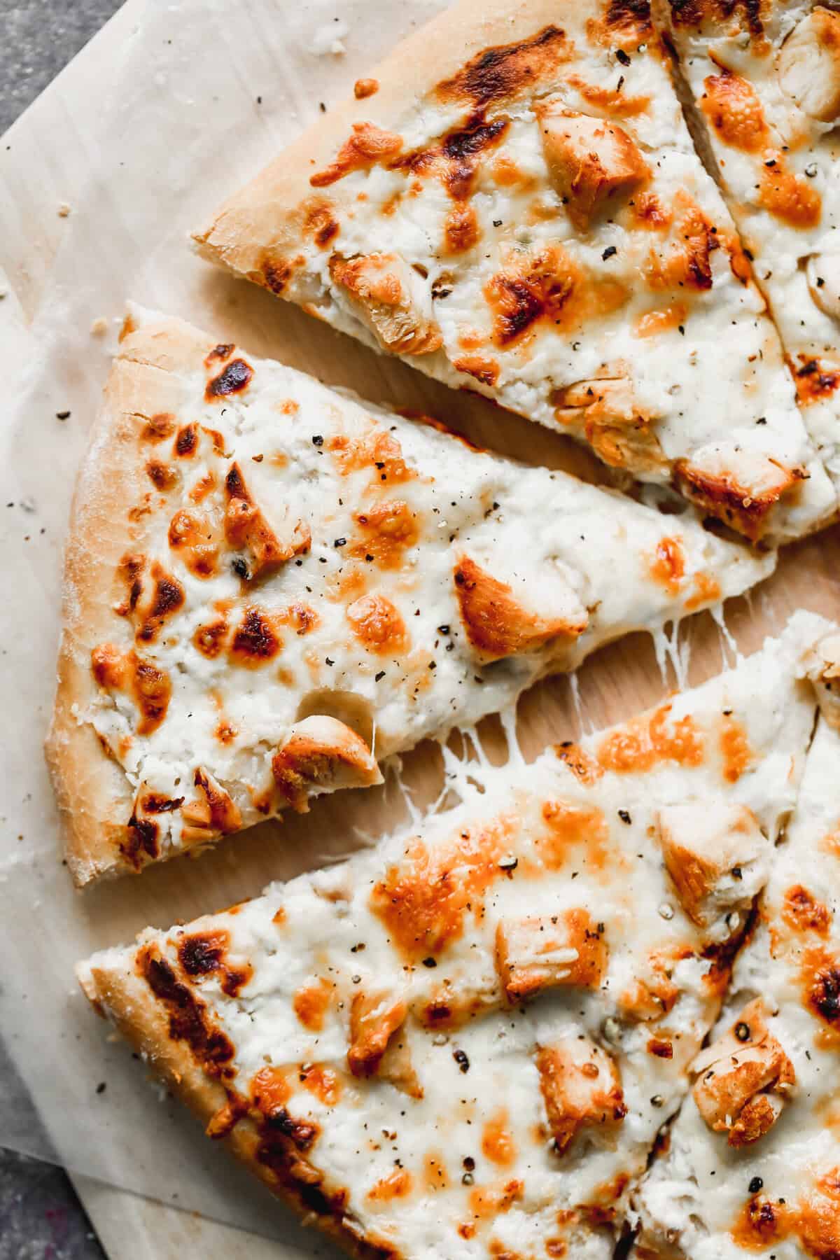 This creamy Alfredo-style pizza is an easy and crowd-pleasing way to turn leftover turkey into something fun.