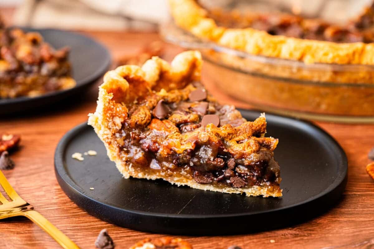 The Best Chocolate Pecan Pie has a rich gooey caramel-like filling with chocolate chips and buttery pecans inside a flaky homemade pie crust.