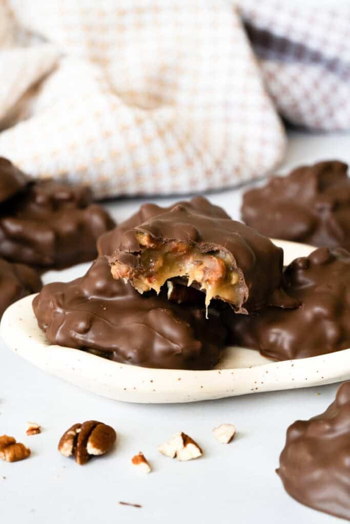 Homemade chocolate turtles are easier and quicker than you think! We make a simple and delicious microwave caramel then stir in chopped pecans and dip in chocolate. Everyone loves them!
