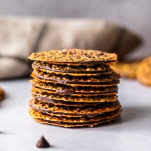This easy Lace Cookies recipe has two delicate, crispy cookies sandwiching a melted chocolate layer. They are incredible!