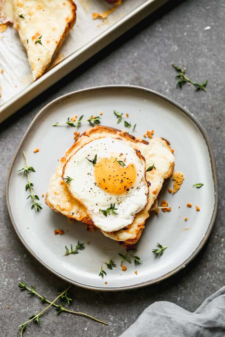 Croque Madame is a breakfast-ready twist on ham sandwiches topped with a soft fried egg.